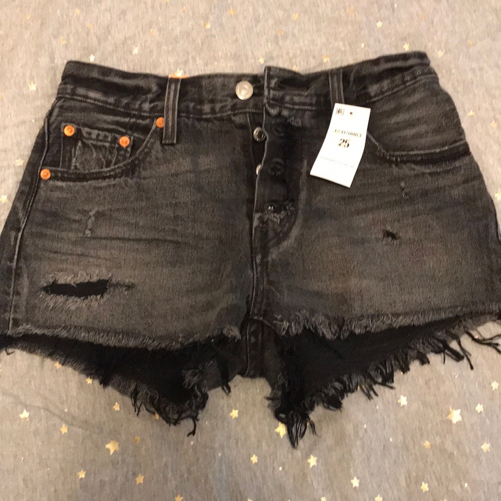 Distressed black high waisted Levi Shorts.